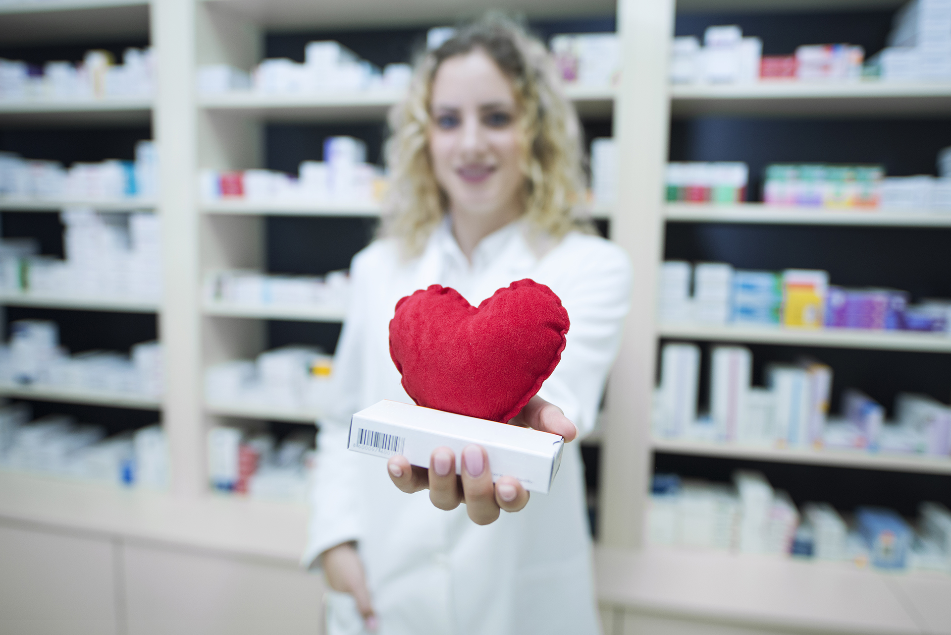 pharmacist white uniform holding medicines cardiovascular disease